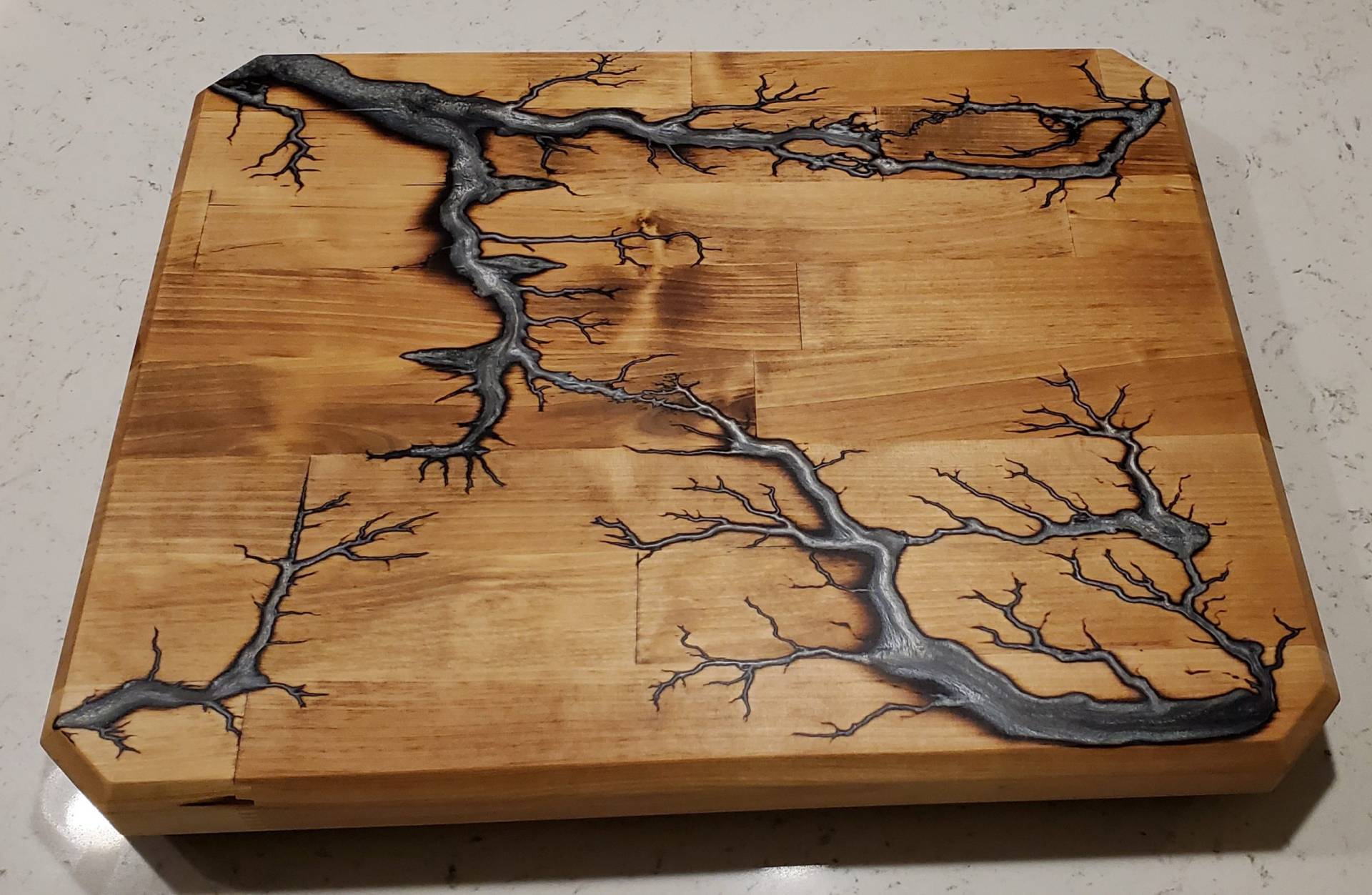 Cutting board with burnt design filled with resin